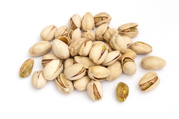 group of green pistachios and their husks