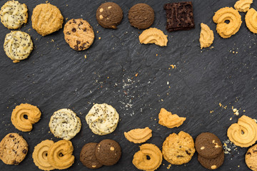 Top view different cookies on table top, Flat lay of various cookies on black stone for background, Prepared cookies food buffet on table for serve