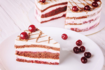 Chocolate cake with mousse, decorated cherries