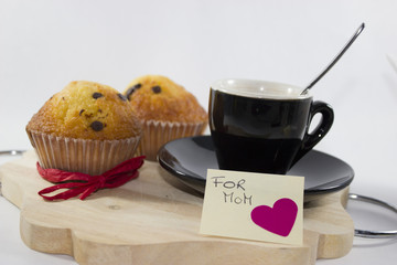 background for mother's day, with a small cup of coffee and two muffins