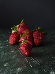 Group of fresh strawberries over green textured background