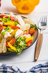 Salad with cheese and fresh vegetables.