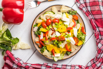 Salad with cheese and fresh vegetables.