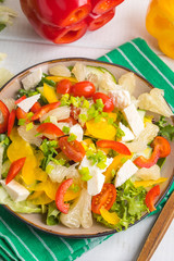 Salad with cheese and fresh vegetables.