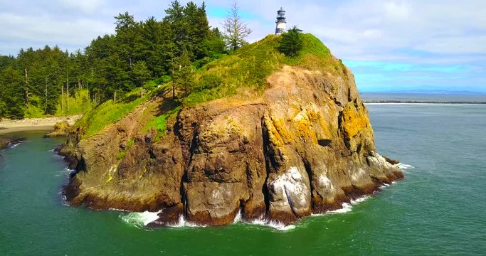 Lighthouse On Cape Disappointment Atop Rocky Cliffs - Sea View Approaching Shore, Washington, USA - 4K Aerial Footage