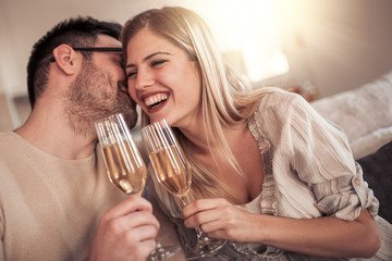 Beautiful couple drinking wine at home