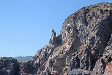 The Aeolian archipelago (UNESCO list), Italy. Rocky coast of the island of Lipari. In the center - Pope John's stone in a tiara in profile