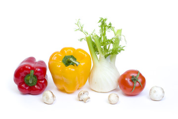 Red pepper with yellow pepper and tomatoes on white background.Vegetables in composition on a white background.