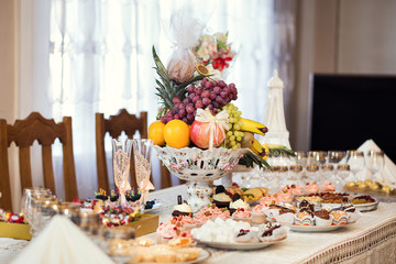 candy bar decorated by delicious sweet buffet with cupcakes and other desserts/candies,happy birthday concept