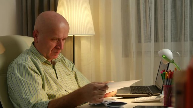 Businessman in Office Room Reading Payment Bills and Checking Invoices