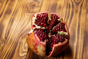 Ripe pomegranate fruit on wooden table