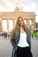 Portrait of beautiful young woman standing in front of Brandenburg Gate in Berlin, Germany. © Bojan