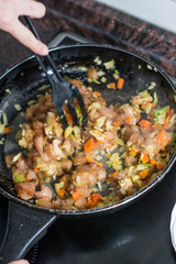 Cooking burrito in a pan with chicken, pepper, tomato for fajitas typical .Latin America food