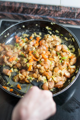 Cooking burrito in a pan with chicken, pepper, tomato for fajitas typical Latin America food