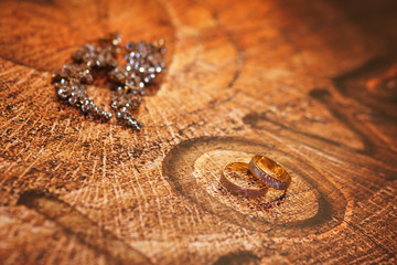Wedding rings on a wooden background.