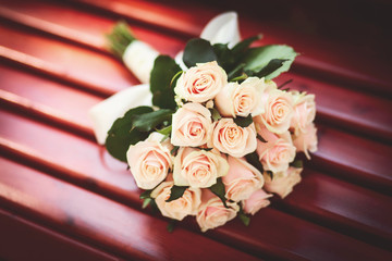 Beautiful wedding bouquet in rustic style with beige roses