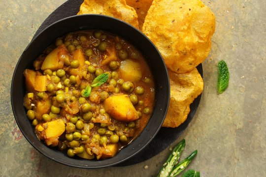 Homemade Aloo Mutter - Indian Curry With Potatoes And Peas And Poori, Overhead View