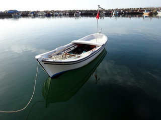 White fishing boat on the quay in the bay