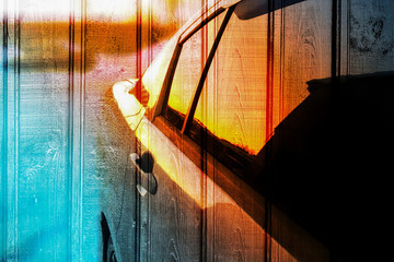 unique texture, wooden background and car at sunset, reflected in mirrors