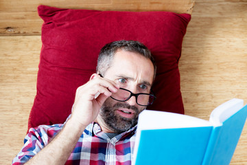 handsome bearded man reading a book