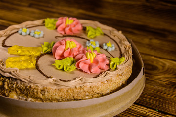 Kiev cake with cream on wooden table