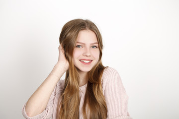 Close up portrait of pretty young schoolgirl with dark blonde hair smiling charmingly