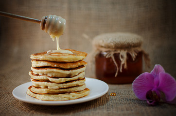 Fried pancakes are a mountain on a plate of sweets
