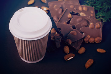 Take away coffee cup. Top view picture of hot drink and chocolate slices.