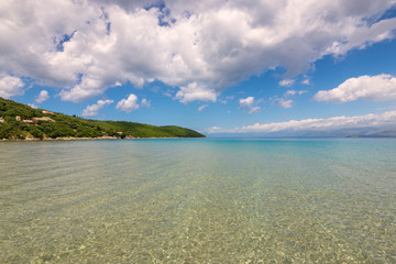 Crystal sea water, summer scenic view of Apras bay near Kassiopi on Corfu island in Greece.