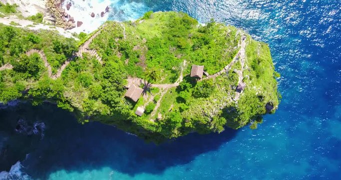Aerial Asceding (Zoom-Out) View Of Jungle Tree Houses On Cliff Point Overlooking Tropical Bay In Nusa Penida, Indonesia