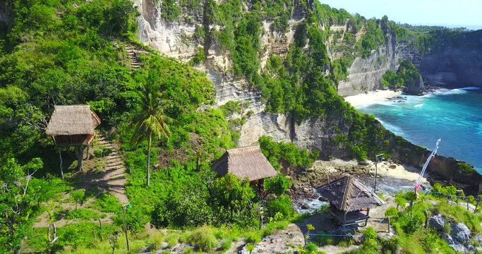 Rotating Aerial View Of Jungle Tree Houses On Cliff Point Overlooking Tropical Bay In Nusa Penida, Indonesia
