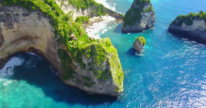 Aerial Fly Over View Of Jungle Tree Houses On Cliff Point Overlooking Tropical Bay In Nusa Penida, Indonesia