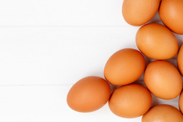 fresh or raw brown eggs on white wooden background, top view, flat lay with copy space, food ingredient