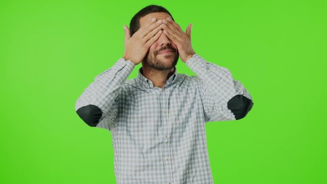 Young man covering his eyes with his hands
