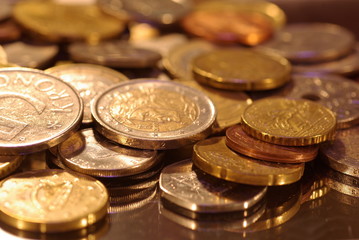 photo of metal coins of different currencies