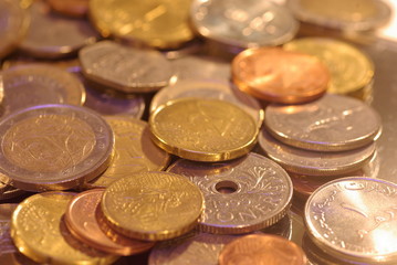 photo of metal coins of different currencies