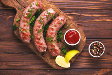 Grilled sausages with lime on iron grill pan