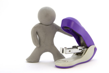 Gray plasticine characters and stapler. Stationery. Isolated on white background