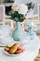 Breakfast by the window, two croissants, a cup of tea on a small table