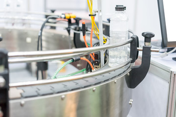 Water bottles on production line, process of bottling pure mineral water into bottles plastic