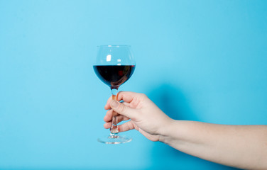 a glass of wine in a woman's hand. alcohol party.