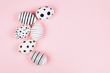 Many easter eggs on pink. Flat lay.