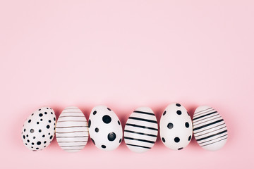 Many easter eggs on pink. Flat lay.