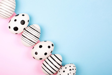 Many easter eggs on pink. Flat lay.