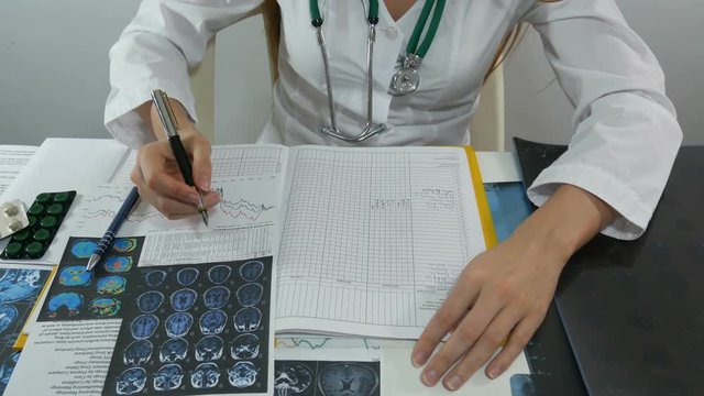 female doctor records the results of an X-ray