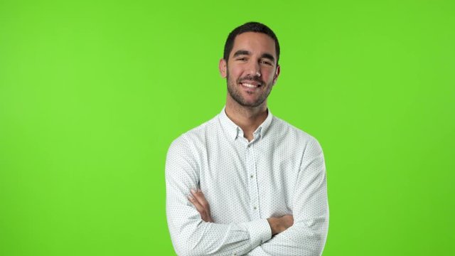 Satisfied young man against green background