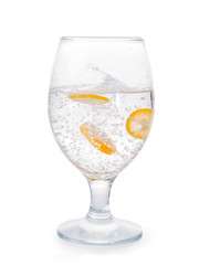 Glass of water with orange fruit slices and splash isolated with clipping path