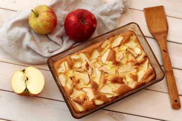 Apple pie with cinnamon on wooden background, top view.