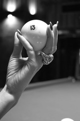 Female hand holds the ball number 13 of Russian billiards