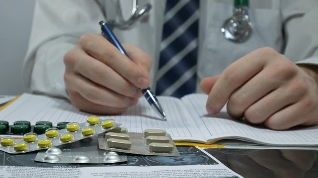 male doctor fills a magazine with pills